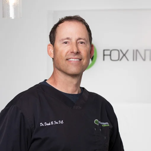 A professional photo of Dr. Derek Fox wearing his scrubs