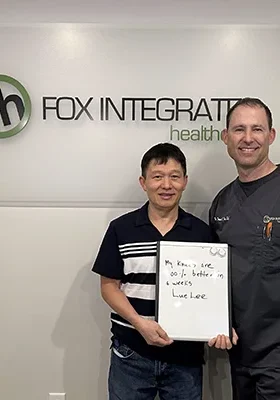 Dr. Derek Fox posing with a satisfied SoftWave Therapy patient