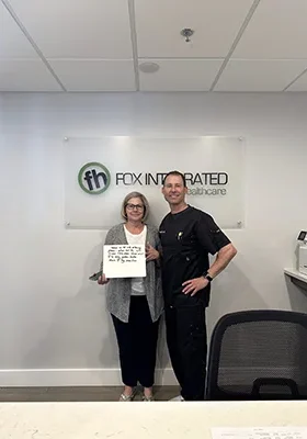 Dr. Derek Fox posing with a middle-aged SoftWave Therapy patient